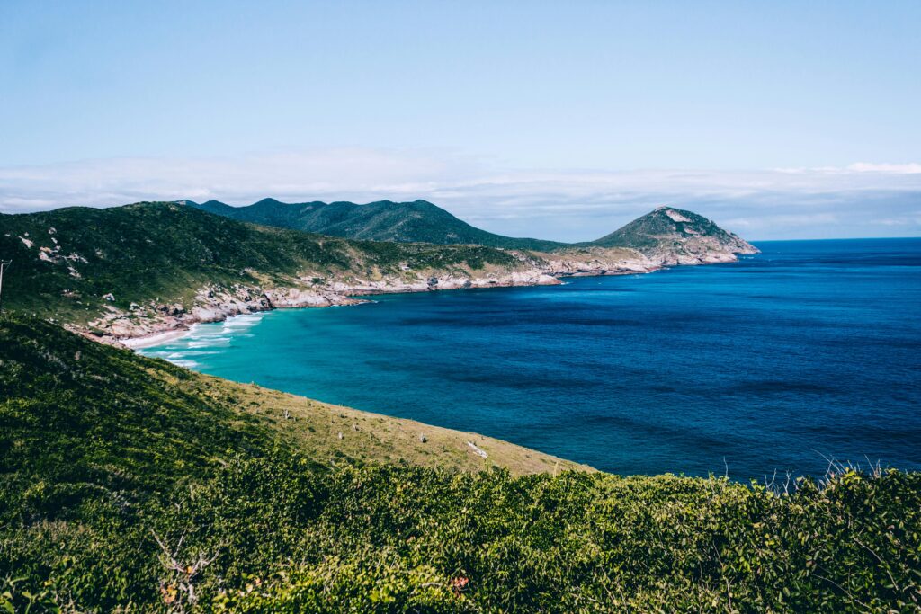 pexels-photo-1072838-1072838 Stunning view of the Arraial do Cabo coastline with turquoise waters and lush hills.